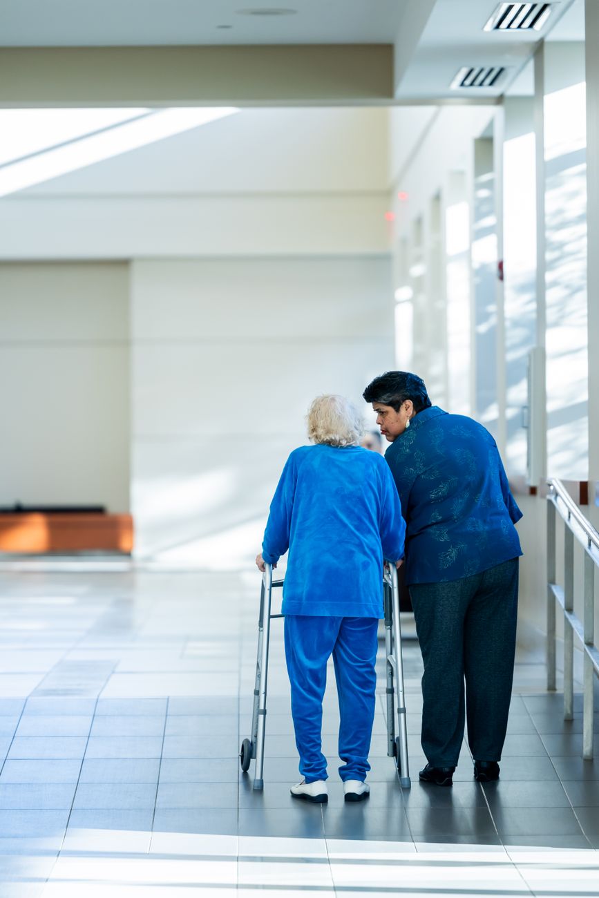 Senior consultant talking lovingly with an older patient in Singapore